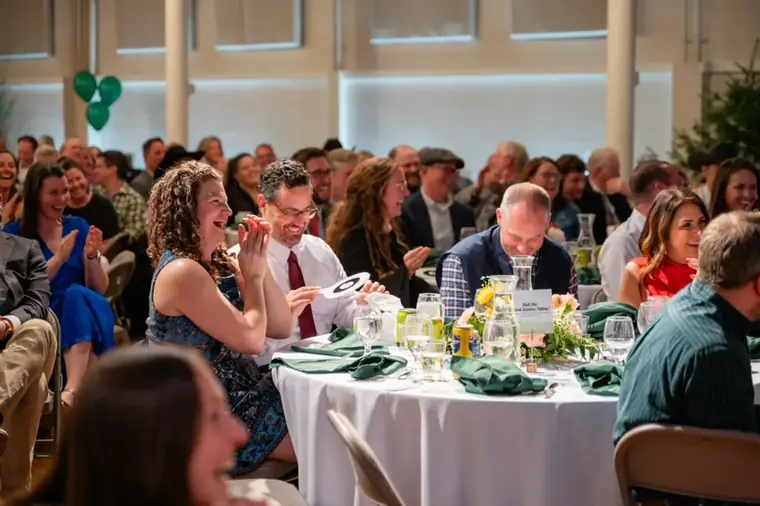 Fundraising gala audience raising paddles